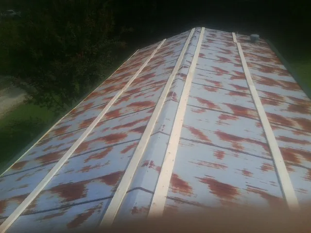 Rusted metal roof panels with new wood purlins before replacement — Storm Damage Roof Repair in Whately by Roofing Brothers